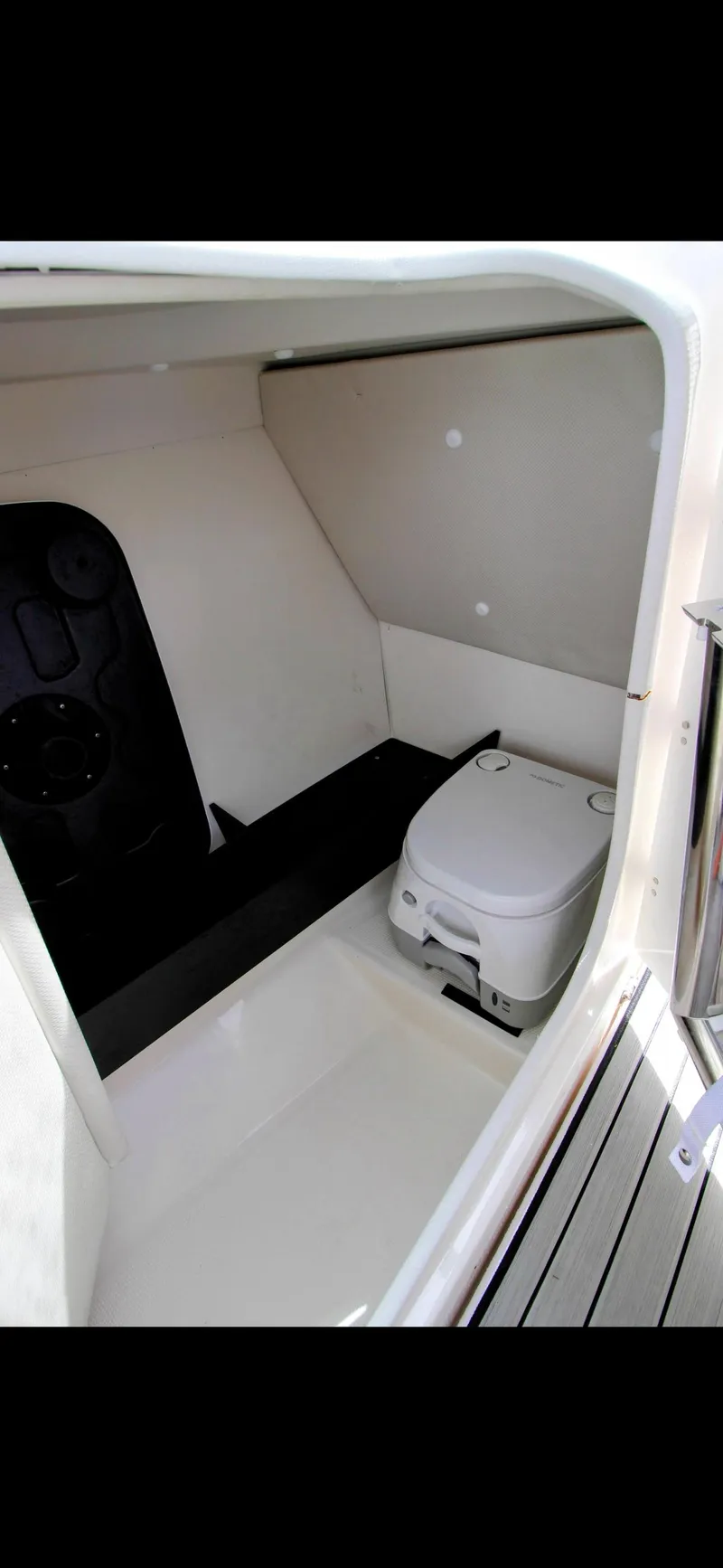 Slide: The Image of 2023 Yamaha Boats 252SD interior cabin with portable toilet. - 10