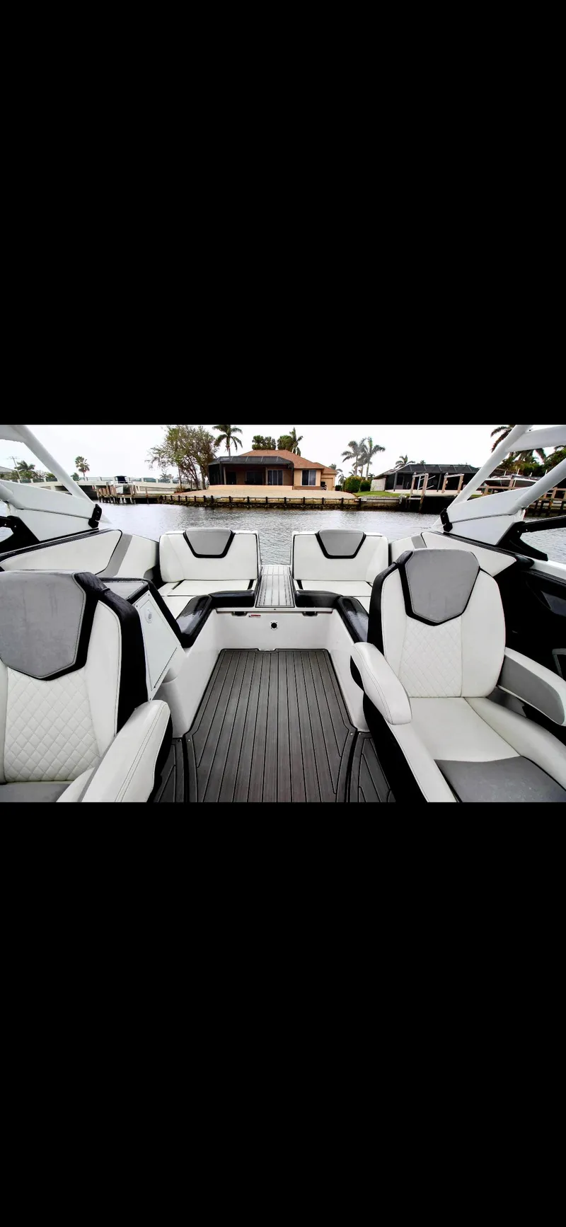 Slide: The Image of 2023 Yamaha Boats 252SD interior with sleek seating and modern design on the water. - 12