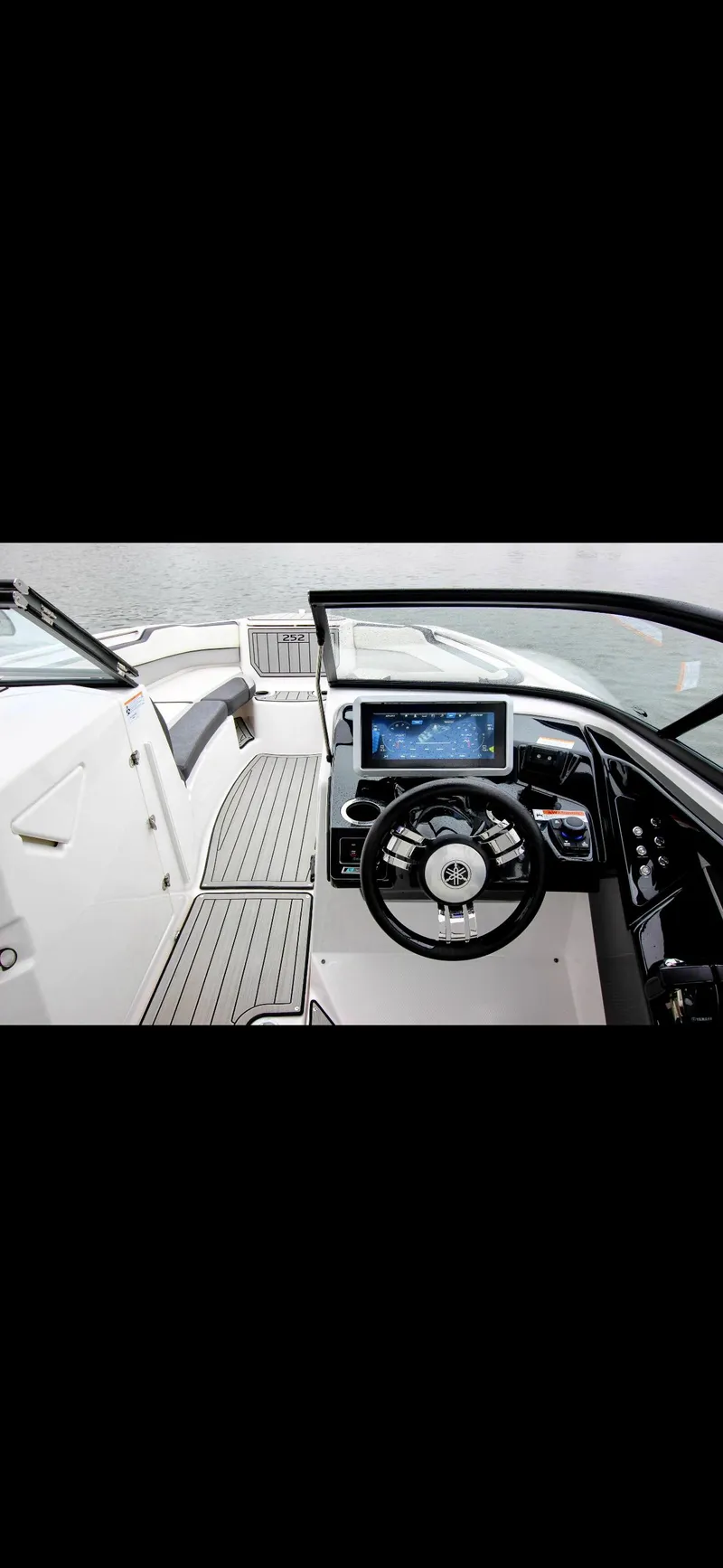 Slide: The Image of 2023 Yamaha Boats 252SD cockpit with modern dashboard and steering wheel. - 17