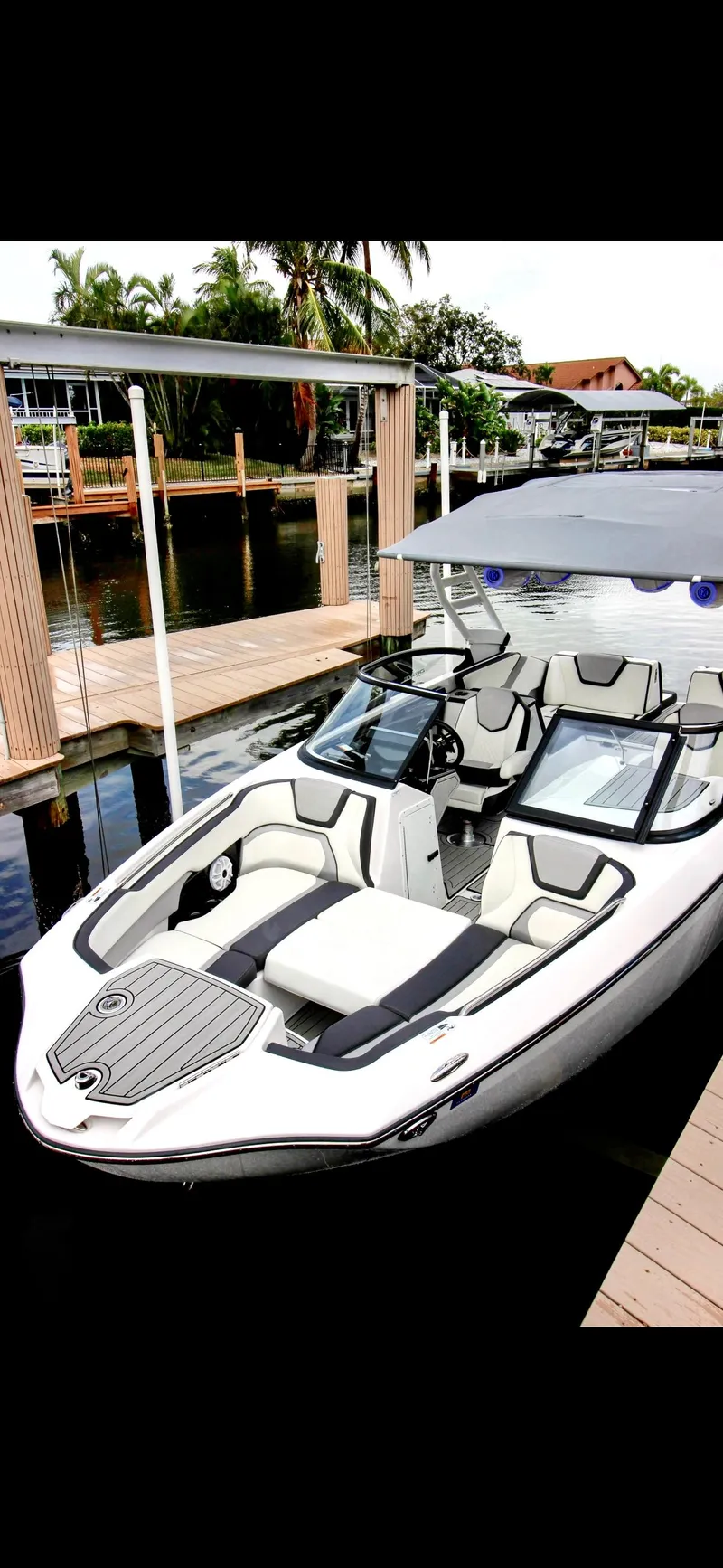 Slide: The Image of 2023 Yamaha Boats 252SD docked, showcasing sleek design and modern features. - 2