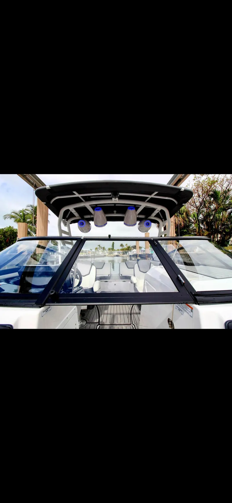 Slide: The Image of 2023 Yamaha Boats 252SD with sleek design and modern features, showcasing the cockpit and speakers. - 8