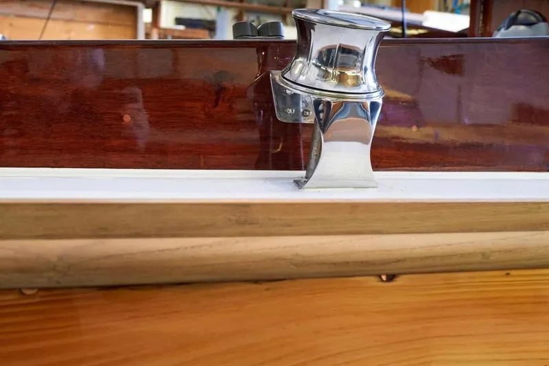 Slide: The Image of Polished metal cleat on 1979 Nordic Folkboat with wooden finish. - 12