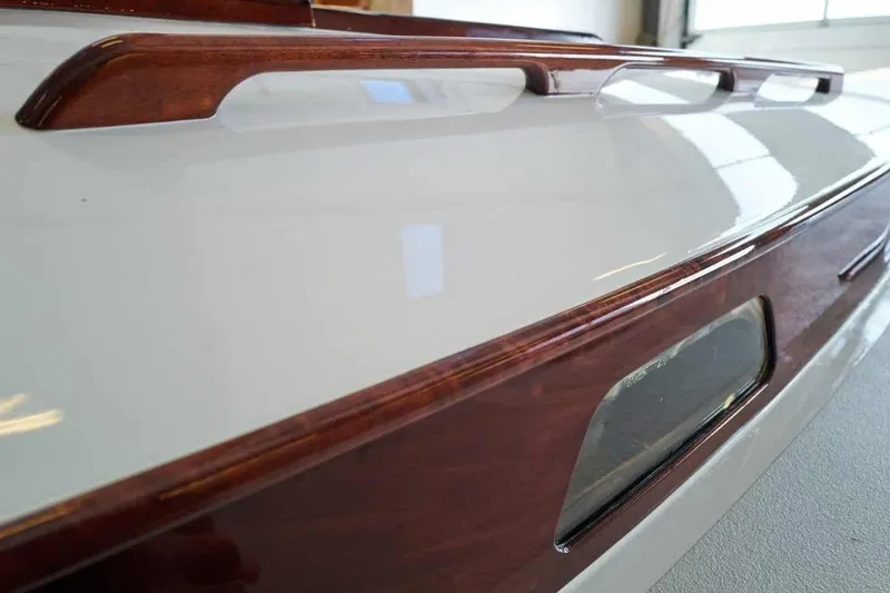 Slide: The Image of Close-up of a 1979 Nordic Folkboat's polished wooden and white fiberglass deck. - 14