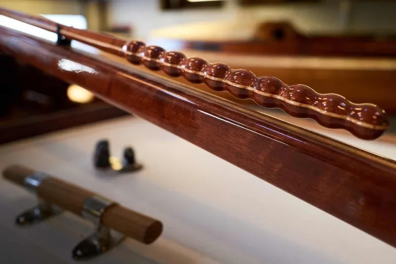 Slide: The Image of Close-up of a 1979 Nordic Folkboat's polished wooden tiller and fittings. - 17