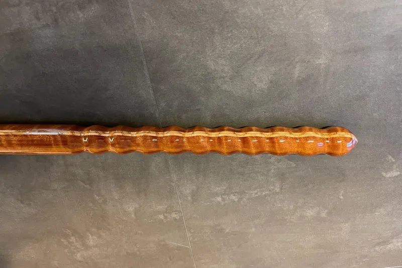 Slide: The Image of Polished wooden tiller from a 1979 Nordic Folkboat, showcasing intricate craftsmanship. - 18