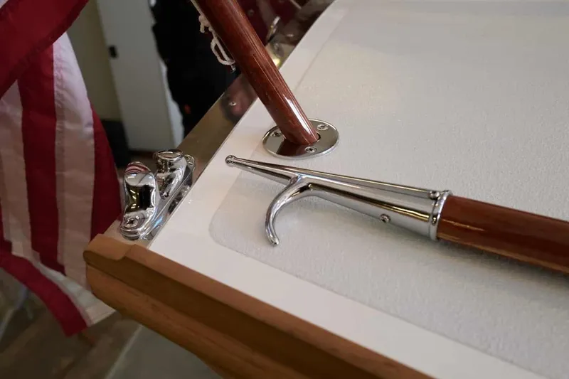 Slide: The Image of 1979 Nordic Folkboat deck with flag, cleat, and boat hook detail. - 19