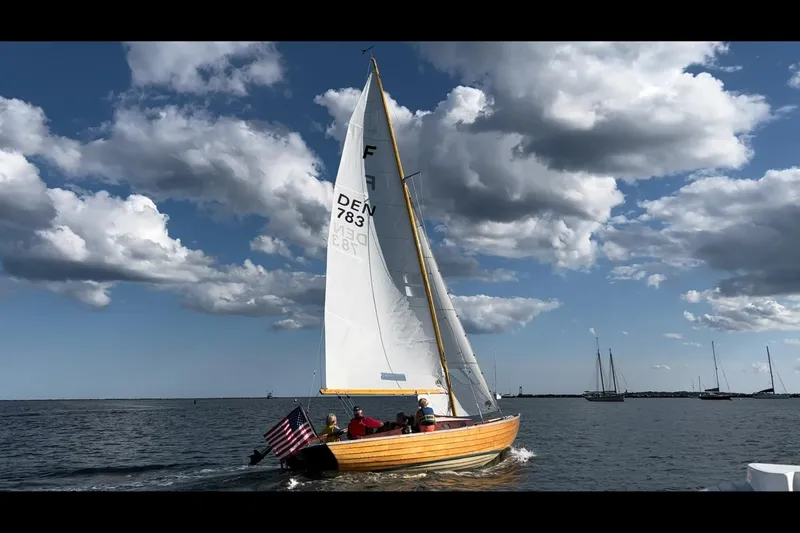 Slide: The Image of Sailing Nordic Folkboat 1979 on open water under cloudy sky, American flag displayed. - 4