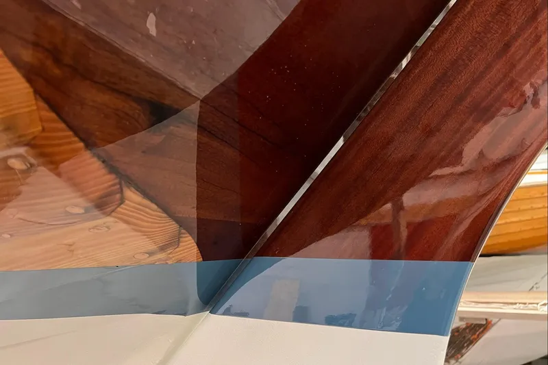 Slide: The Image of Close-up of a 1979 Nordic Folkboat's polished wooden hull and keel. - 9