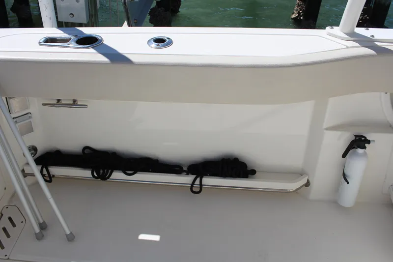 Slide: The Image of 2014 Boston Whaler 270 Vantage boat interior storage compartment with safety equipment. - 15