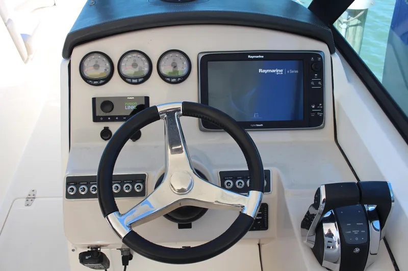 Slide: The Image of Steering console of a 2014 Boston Whaler 270 Vantage with gauges and Raymarine display. - 7