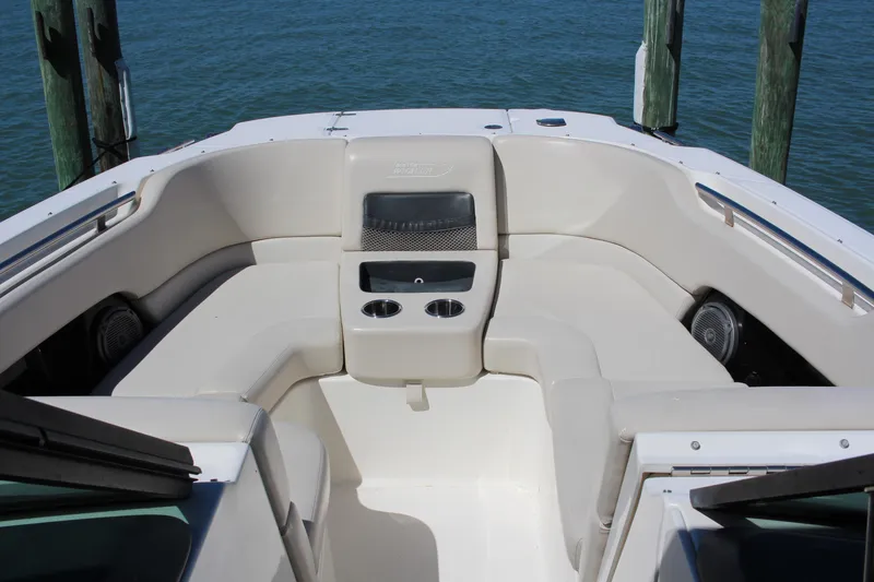 Slide: The Image of 2014 Boston Whaler 270 Vantage boat interior with seating and cup holders. - 8
