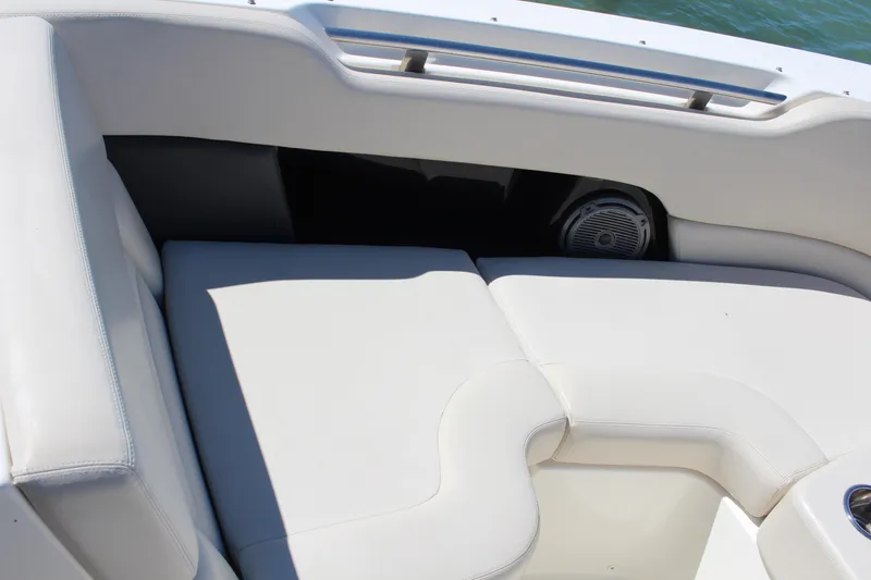 Slide: The Image of 2014 Boston Whaler 270 Vantage boat interior with white cushioned seating. - 9