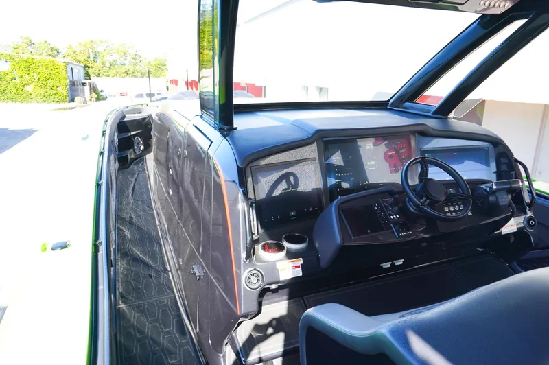 Slide: The Image of 2022 MTI 50V Center Console boat interior with modern dashboard and steering wheel. - 11