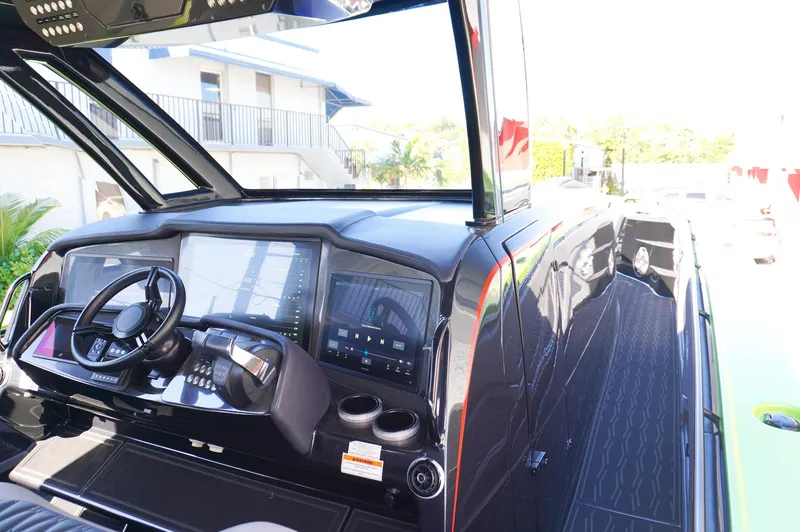 Slide: The Image of 2022 MTI 50V Center Console boat interior with modern dashboard and steering wheel. - 12