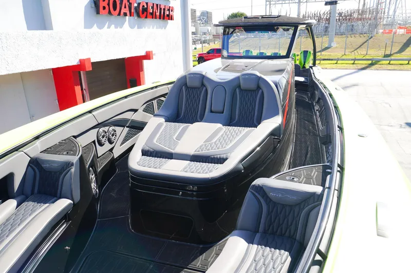 Slide: The Image of 2022 MTI 50V Center Console boat with luxurious seating at a boat center. - 17