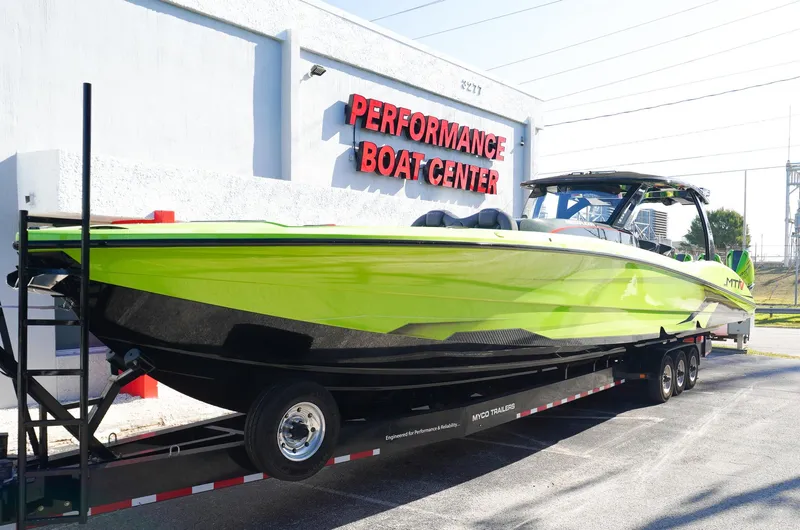 Slide: The Image of 2022 MTI 50V Center Console boat in vibrant green at Performance Boat Center. - 3