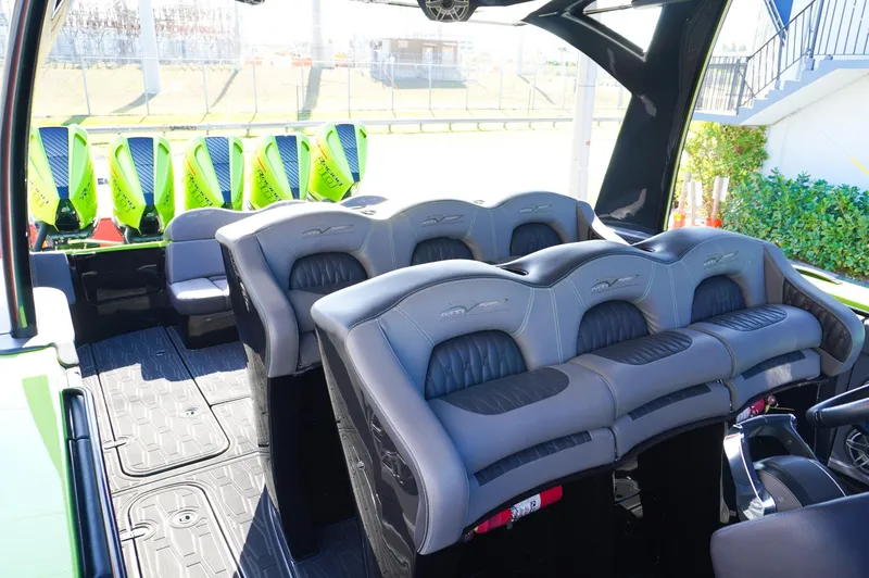 Slide: The Image of 2022 MTI 50V Center Console boat interior with luxurious seating and vibrant green accents. - 30