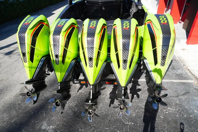 Slide: The Image of Four vibrant green outboard motors on a 2022 MTI 50V Center Console boat. - 33
