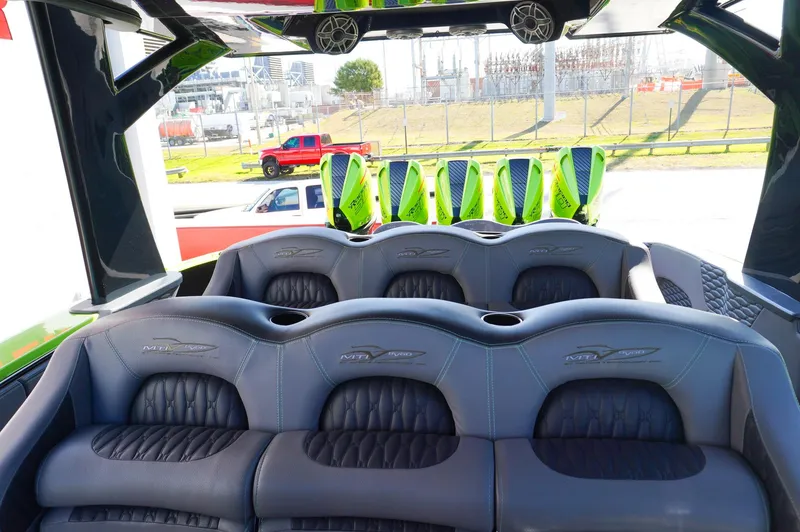 Slide: The Image of 2022 MTI 50V Center Console boat interior with luxurious seating and vibrant green accents. - 36