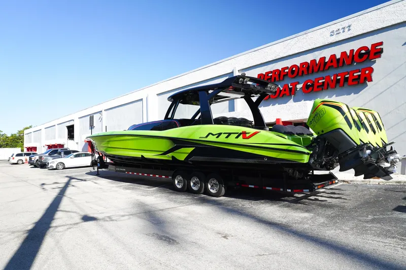 Slide: The Image of 2022 MTI 50V Center Console boat in vibrant green at Performance Boat Center. - 38