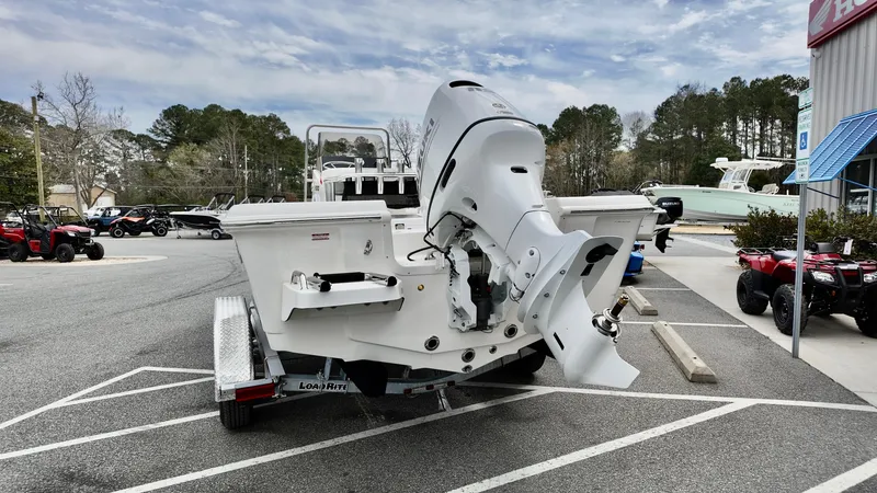 Slide: The Image of 2025 Bulls Bay 2000 boat with outboard motor on a trailer in a parking lot. - 3