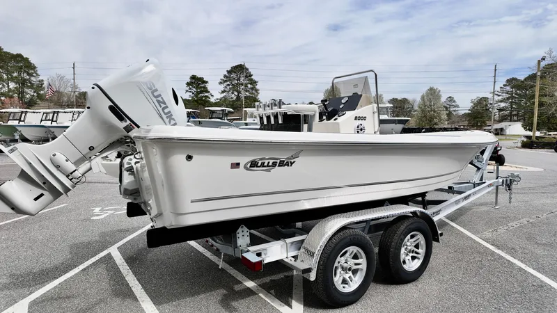Slide: The Image of 2025 Bulls Bay 2000 boat on trailer in parking lot, side view. - 4