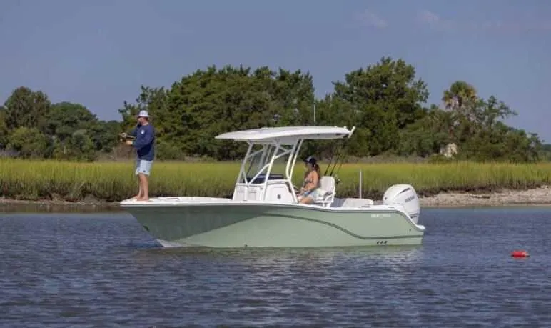 Slide: The Image of 2025 Sea Fox 228 Commander boat on calm water with two people onboard. - 0