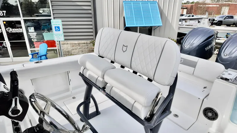 Slide: The Image of 2025 Sea Fox 268 Commander boat interior with white seating and steering wheel. - 10