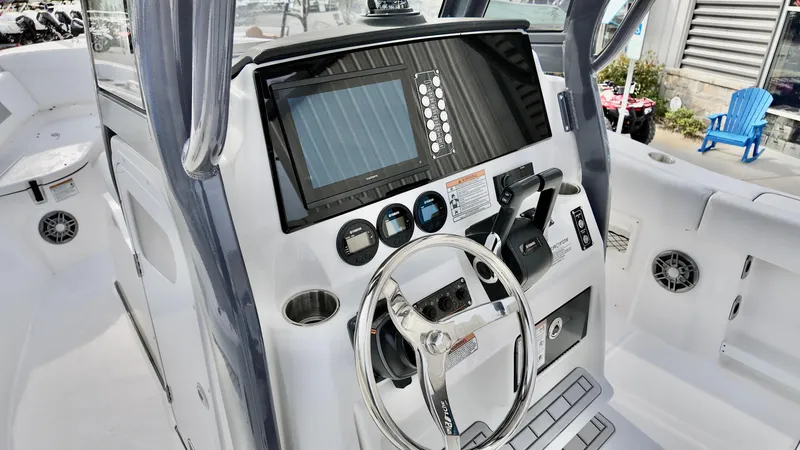Slide: The Image of 2025 Sea Fox 268 Commander boat dashboard with steering wheel and modern controls. - 11
