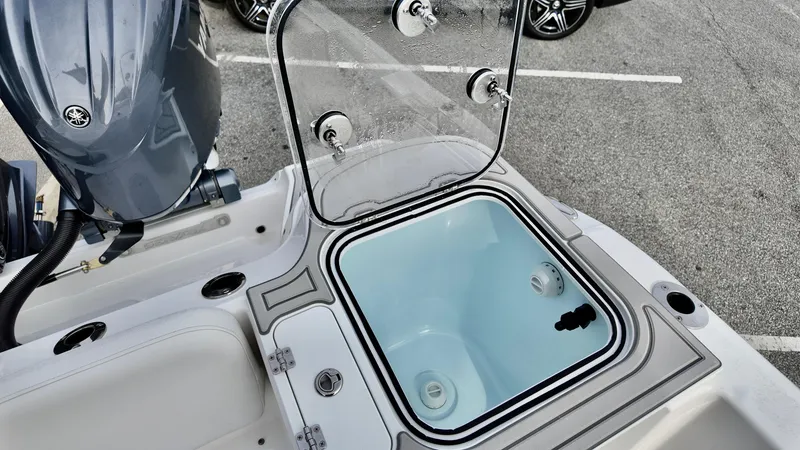 Slide: The Image of 2025 Sea Fox 268 Commander boat with open storage compartment and visible engine. - 13