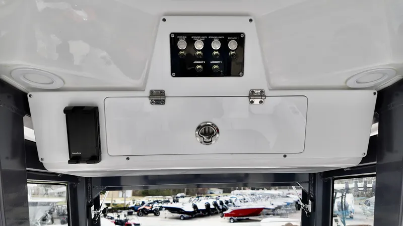 Slide: The Image of 2025 Sea Fox 268 Commander control panel with switches and storage compartment. - 17