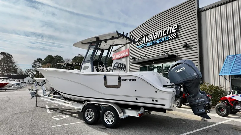 The Image of 2025 Sea Fox 268 Commander boat on trailer at Avalanche Motorsports dealership. - 2
