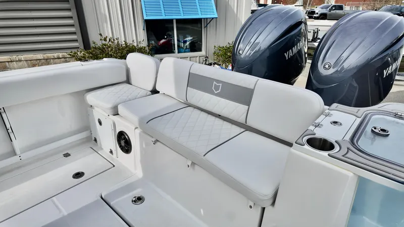 Slide: The Image of 2025 Sea Fox 268 Commander boat interior with cushioned seating and dual Yamaha engines. - 20