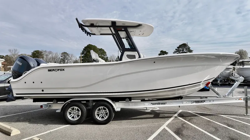 Slide: The Image of 2025 Sea Fox 268 Commander boat on trailer, side view, in parking lot. - 4