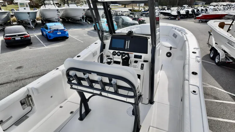 Slide: The Image of 2025 Sea Fox 268 Commander boat interior with modern console and seating, parked in a marina. - 6
