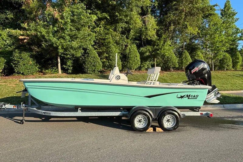 The Image of 2025 Mako Pro Skiff 19 CC boat on trailer, parked on a sunny street. - 0