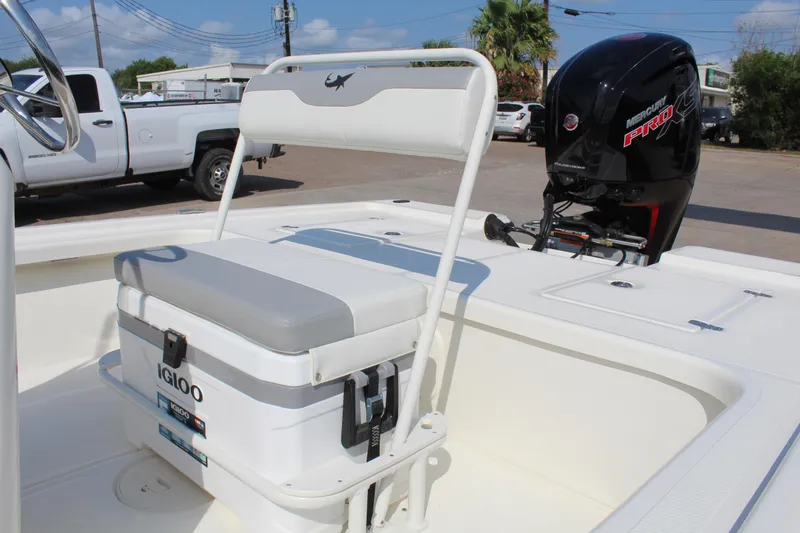 Slide: The Image of 2025 Mako 18 LTS boat interior with Igloo cooler and powerful outboard motor. - 10