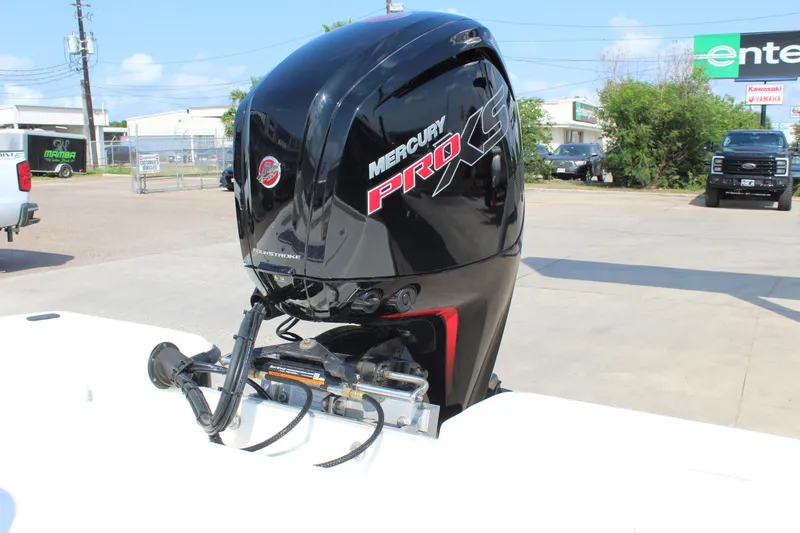 Slide: The Image of 2025 Mako 18 LTS boat with Mercury Pro XS outboard motor in a parking lot. - 11
