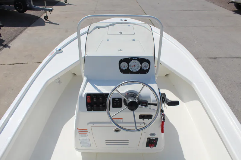 Slide: The Image of 2025 Mako 18 LTS boat dashboard with steering wheel and control panel. - 12
