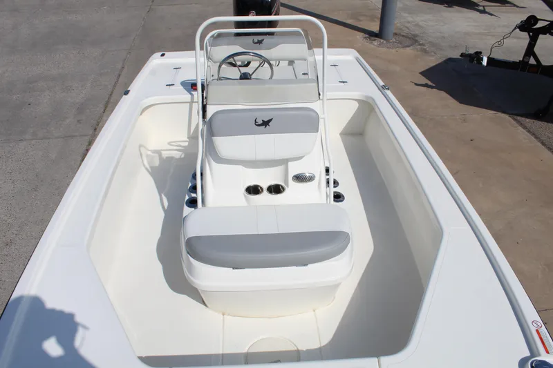 Slide: The Image of 2025 Mako 18 LTS boat interior with steering console and seating. - 13