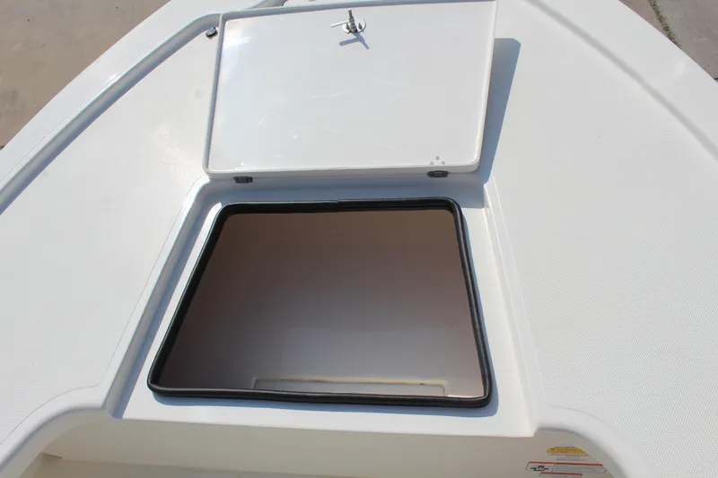 Slide: The Image of Open storage compartment on 2025 Mako 18 LTS boat deck. - 15