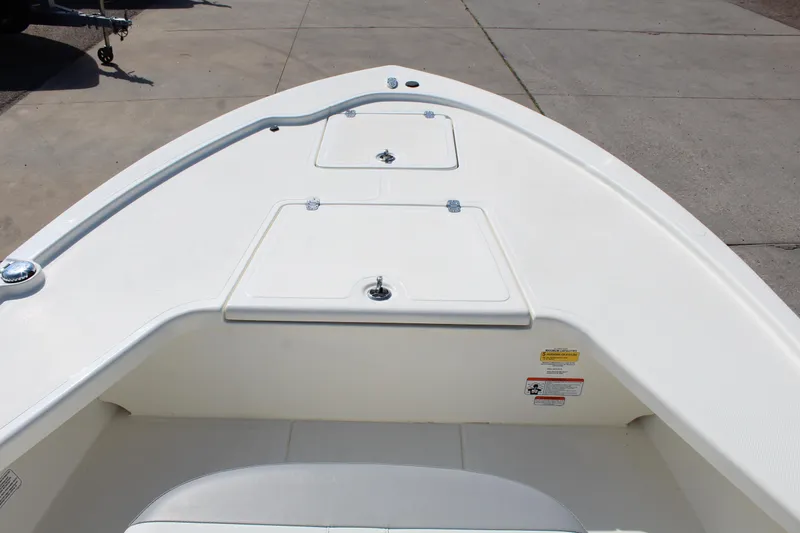 Slide: The Image of 2025 Mako 18 LTS boat deck with storage compartments, viewed from above. - 16