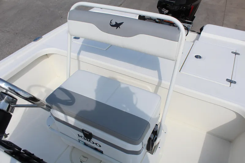 Slide: The Image of 2025 Mako 18 LTS boat interior with cushioned seating and steering wheel. - 17