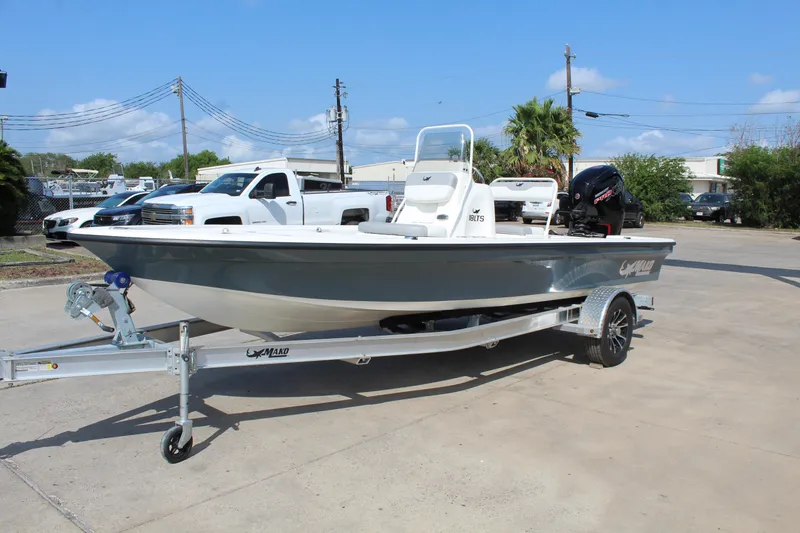Slide: The Image of 2025 Mako 18 LTS boat on trailer, parked outdoors, clear sky background. - 3
