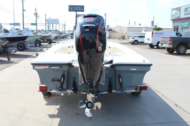 Slide: The Image of 2025 Mako 18 LTS boat with outboard motor, parked in a dealership lot. - 6