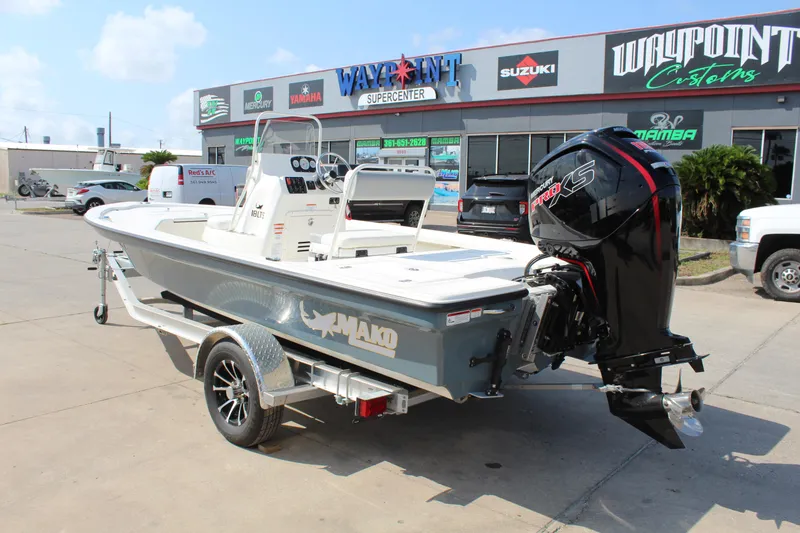 Slide: The Image of 2025 Mako 18 LTS boat on trailer, displayed outside dealership. - 7
