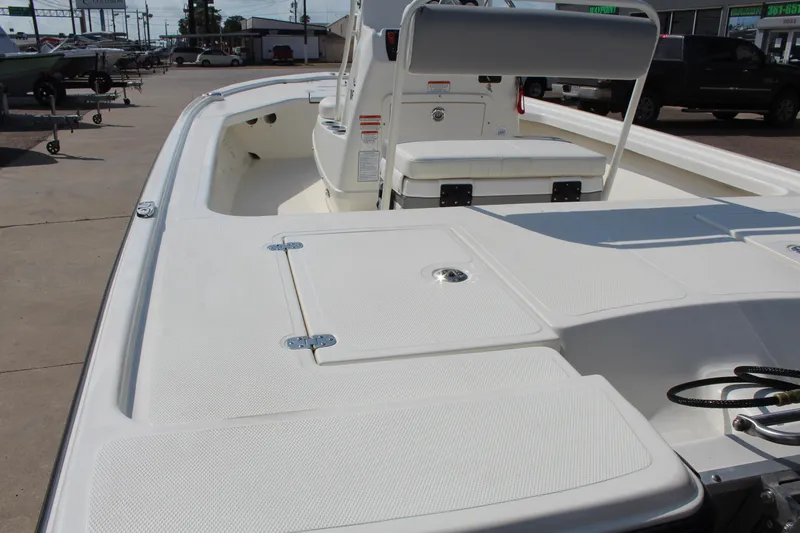 Slide: The Image of 2025 Mako 18 LTS boat, spacious deck, white finish, outdoor setting. - 8