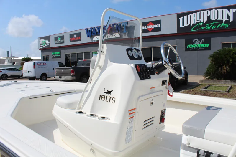 Slide: The Image of 2025 Mako 18 LTS boat console with steering wheel, displayed at dealership. - 9