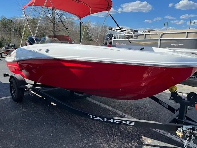 Slide: The Image of 2025 Tahoe T18 boat with red hull and canopy on a trailer. - 1