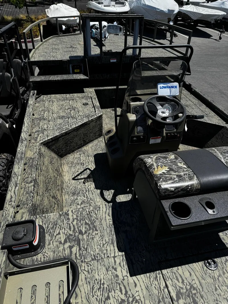 Slide: The Image of 2025 Tracker Grizzly 2072 CC Sportsman boat with camouflage design and steering console. - 4